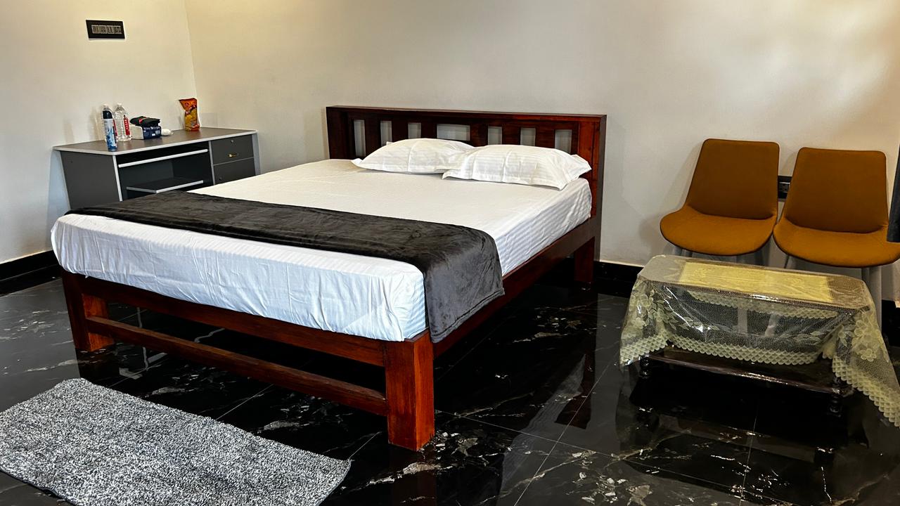 Guest room with wooden bed and seating